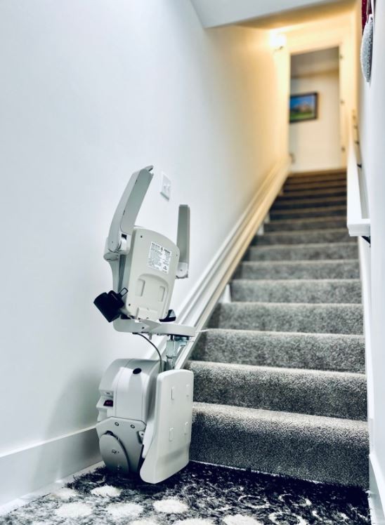 Bruno stairlift from Lifeway Mobility with components folded up at bottom landing of stairs in Columbus OH area home