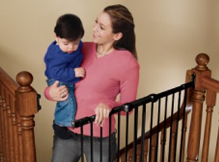 Mom Carrying Baby using Childproofing Gate