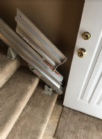 Bruno manual folding rail to prevent tripping hazard at bottom landing of stairs