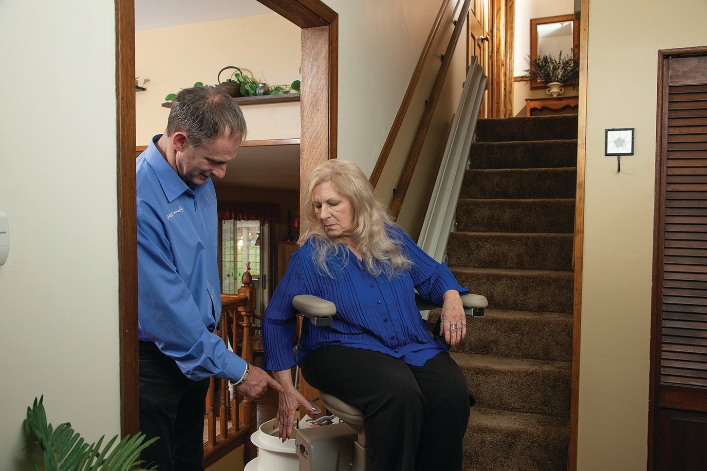 Lifeway Mobility tech shows customer how to operate her new stair lift