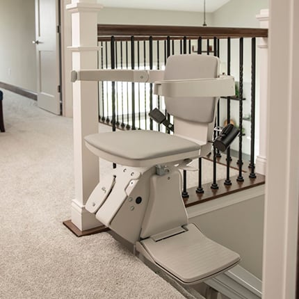 stair lift swiveled at top landing of stairs for safe exit in home