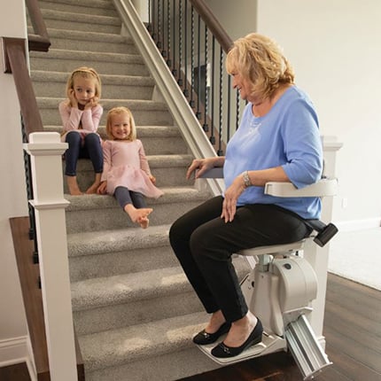 Man riding Bruno Elan home stair lift in Chicago suburb from Lifeway Mobility