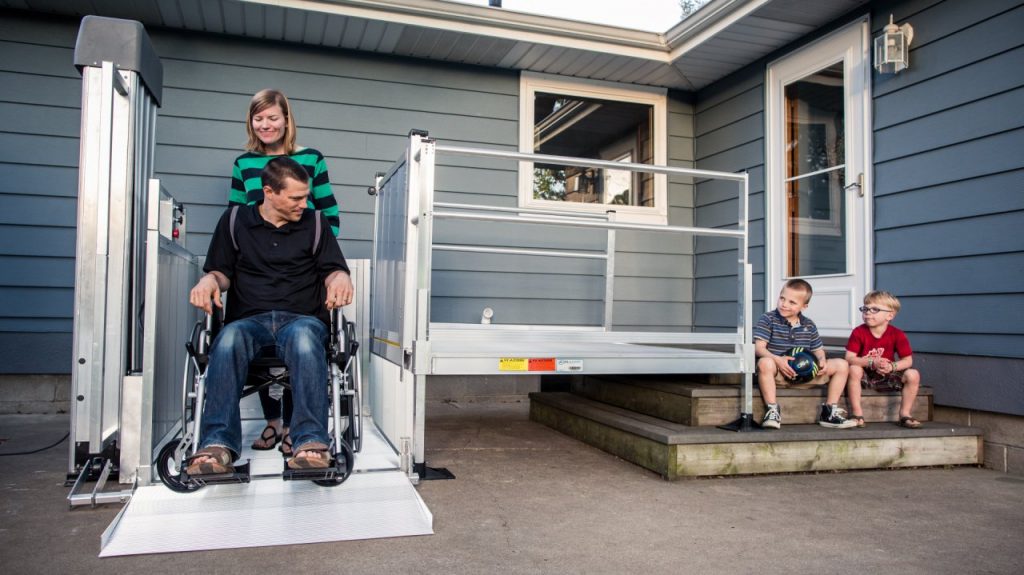 EZ-Access PASSPORT Lift being used by a client and his wife, while their children watch