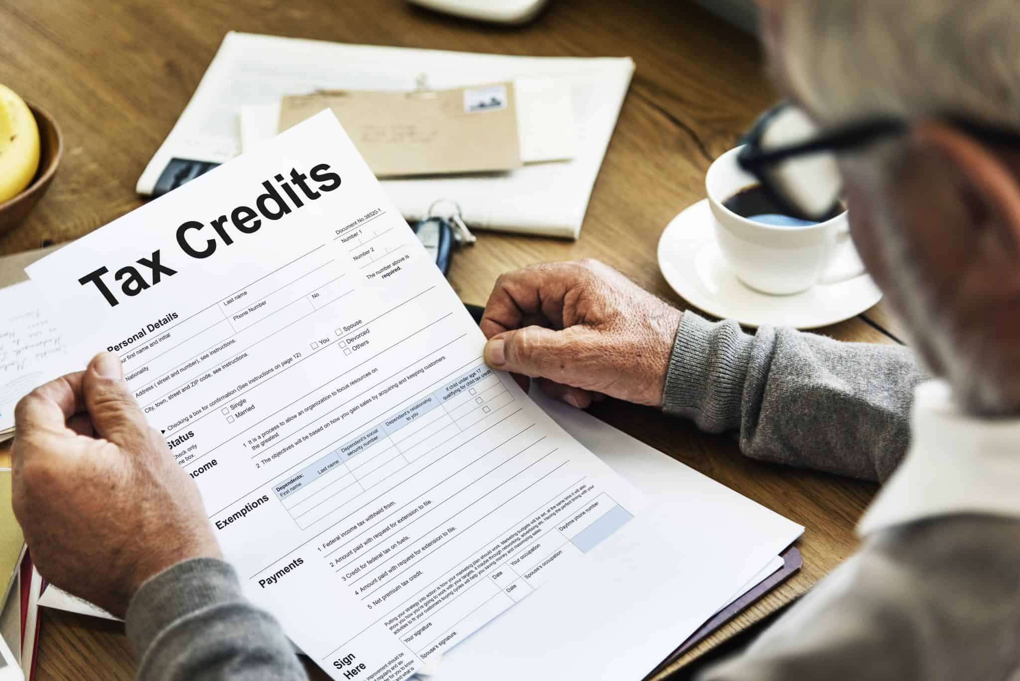 man holding tax credit paper