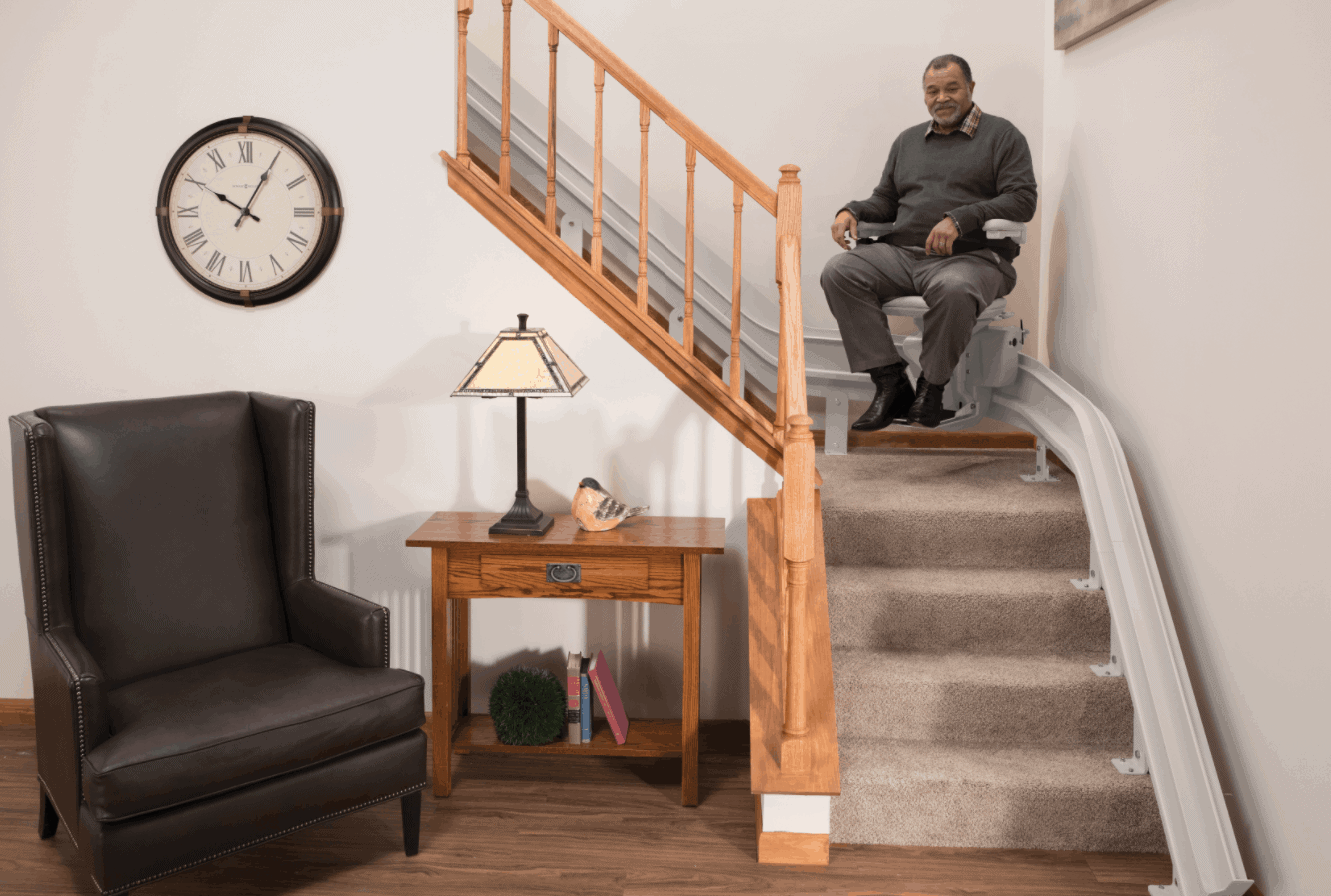 man riding curved stair lift in home in Evanston, IL