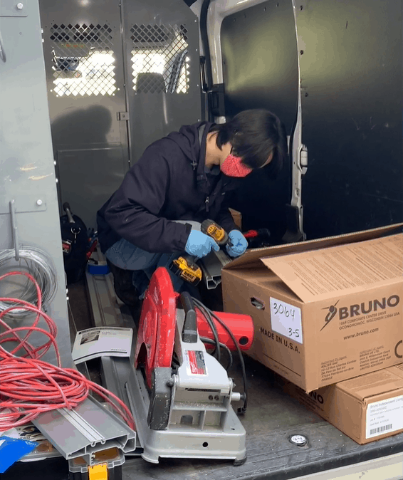 Lifeway Mobility technician preps for stair lift install in van while wearing personal medical equipment