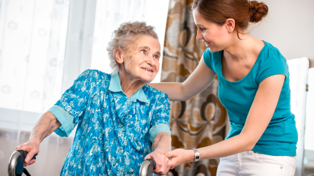 Occupational therapist helps woman with walker in her home