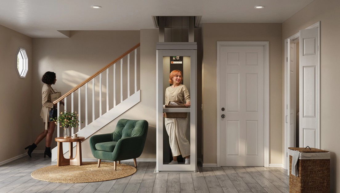 woman uses elevator to bring up laundry basket.