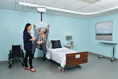 caregiver helping patient transfer in home with Lifeway Mobility ceiling lift