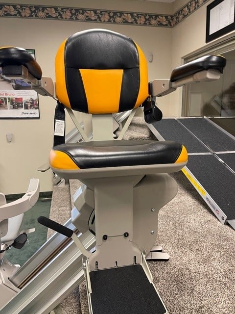 Bruno Elite straight stairlift with custom black & yellow upholstery in Lifeway Pittsburgh showroom