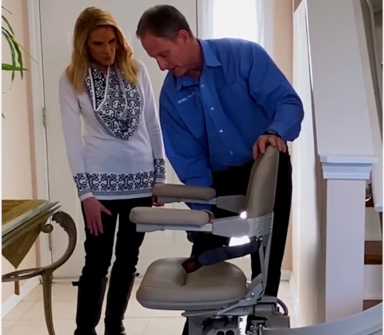 Lifeway Mobility tech shows customer how to operate her new stair lift