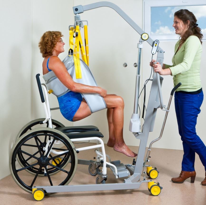 Mobile patient lift 1630 enables caregiver to transfer for patient from bed to shower chair