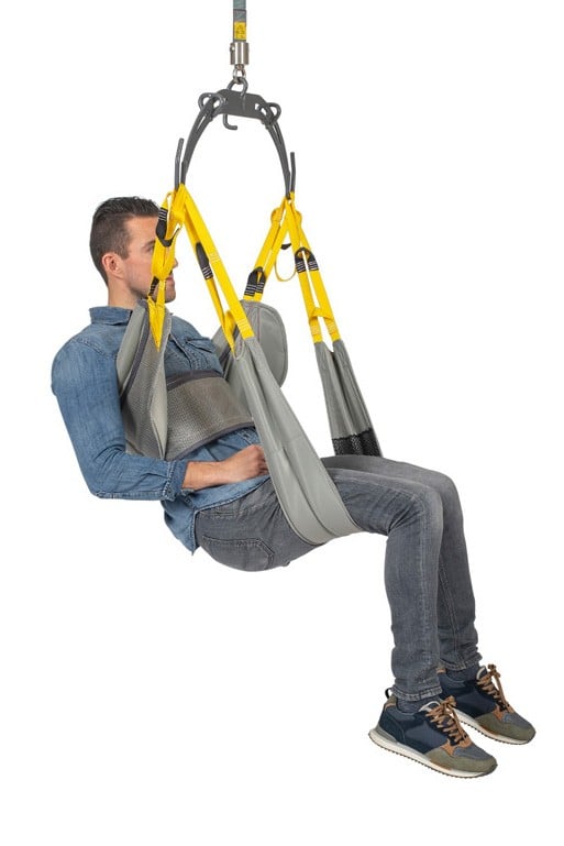 A two-piece hygiene sling used with a SureHands ceiling lift to lift and transfer handicap people