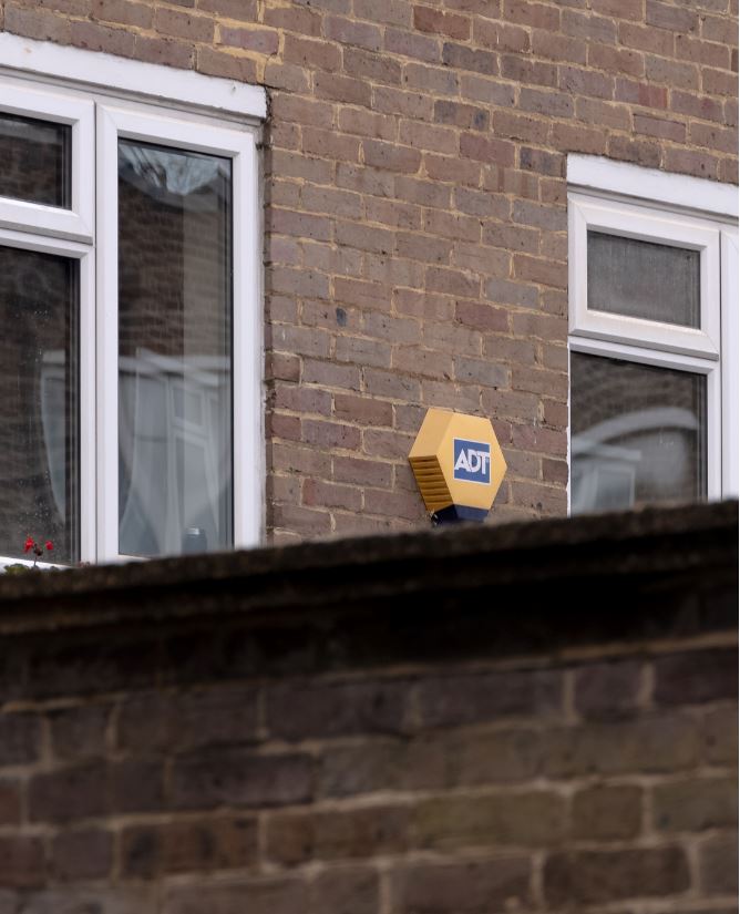 ADT security system installed outside of brick home