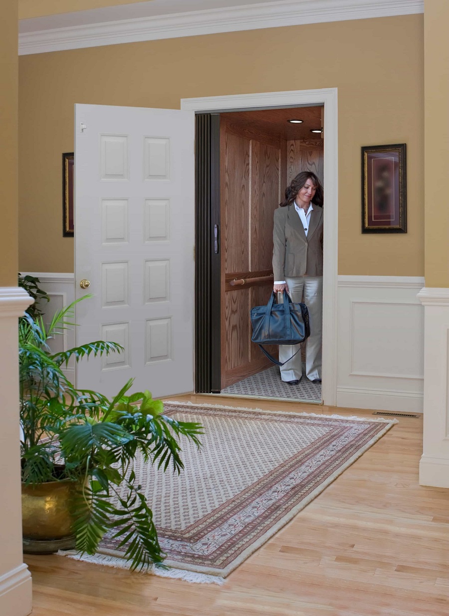 woman-pressing-button-in-her-home-elevator