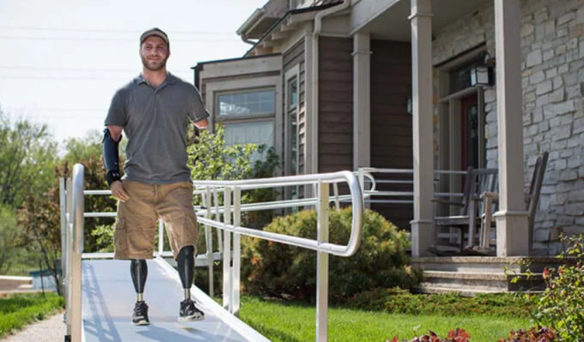 disabled man walking down aluminum wheelchair ramp