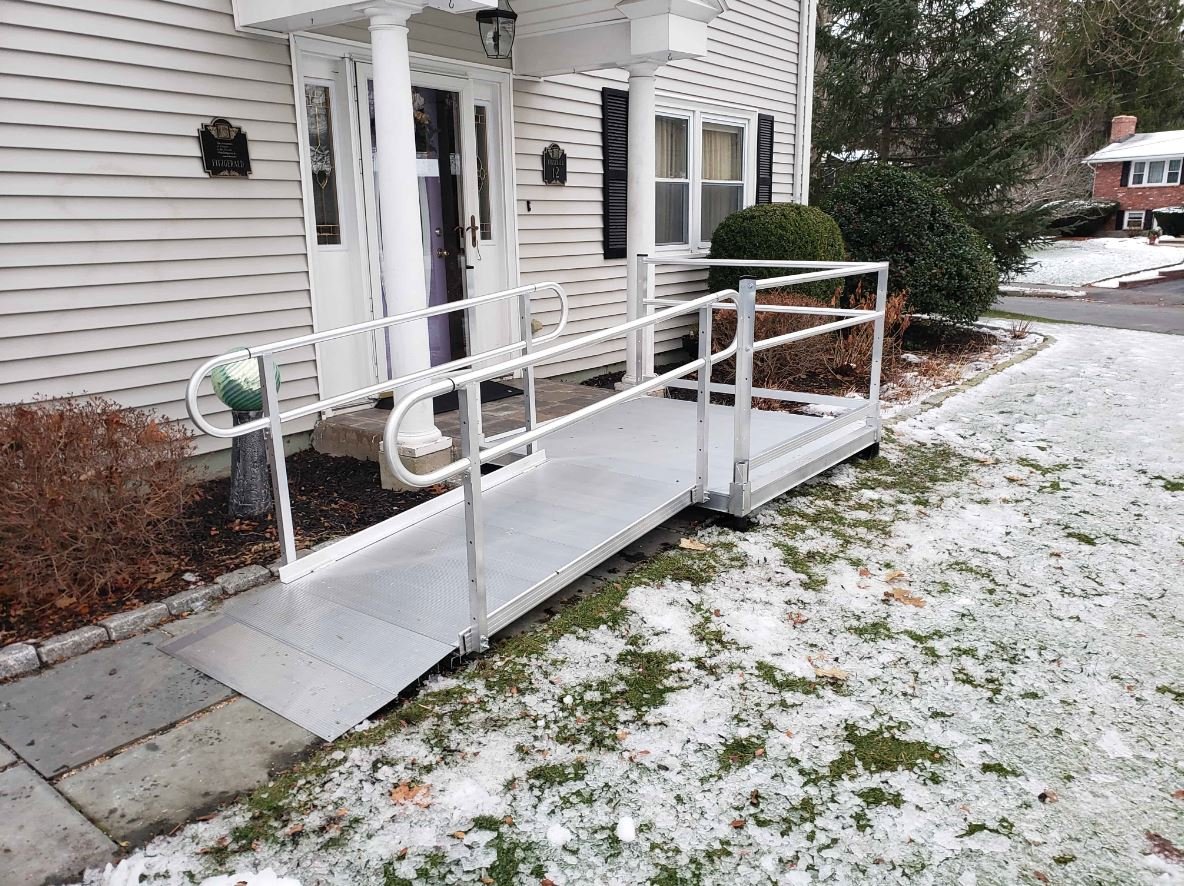 aluminum wheelchair ramp installed during winter with snow on ground in Massachusetts