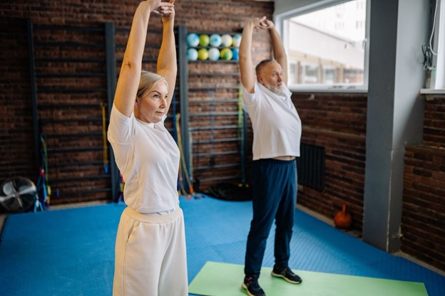 seniors stretching in yoga class