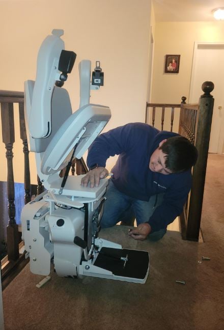 Lifeway Mobility technician professionally installing stairlift in customer's home
