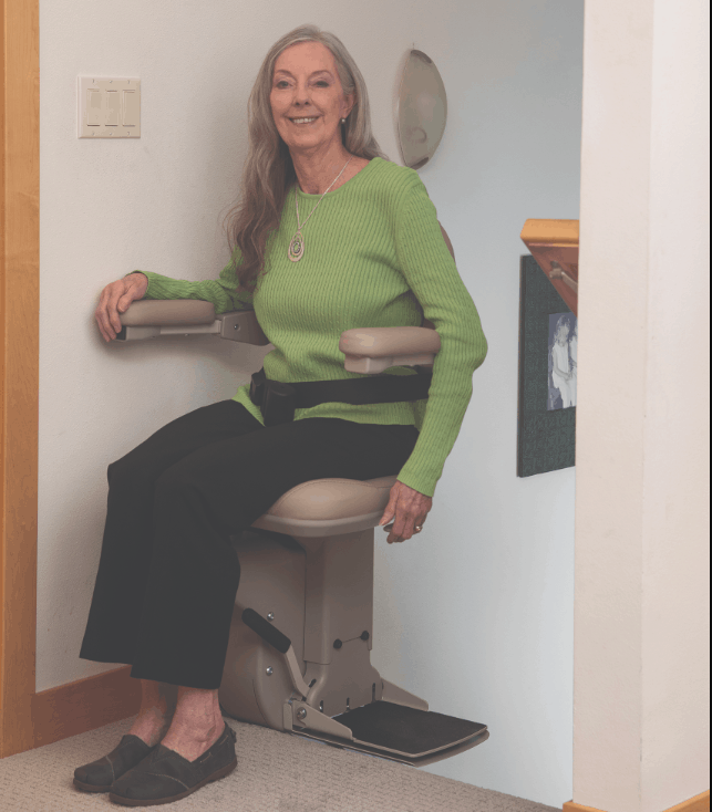 woman utilizing the arm-activated power swivel seat on a Bruno Elite stair lift