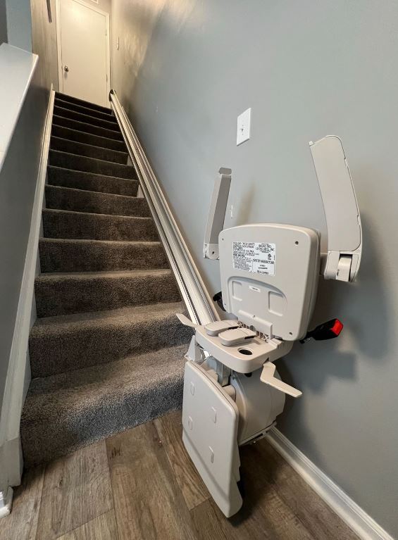 Bruno Elan stairlift from Lifeway Mobility with components folded up at bottom of stairs