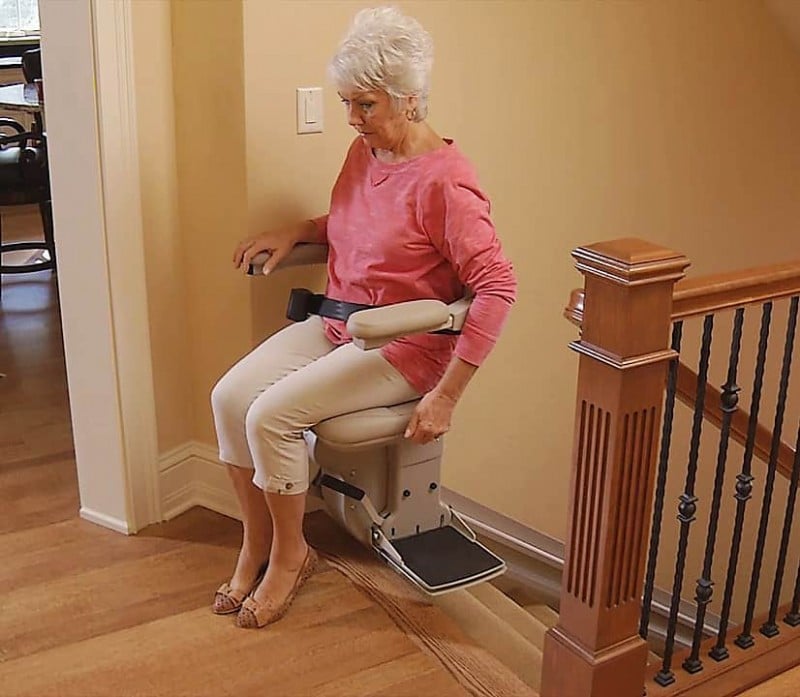 woman-getting-off-rental-stair-lift-at-top-of-staircase