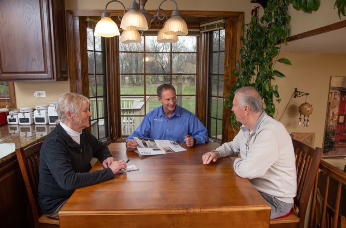 Lifeway Mobility consultant showing stairlift brochure to customers during in-home consultation