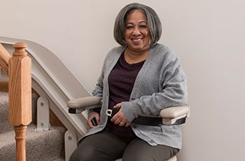 woman smiling while fastening seat belt of chair lift 