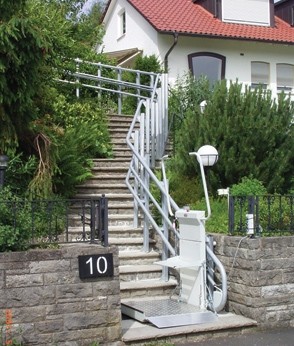 An inclined platform lift allows a rider to roll on/off the platform without having to leave a chair or scooter