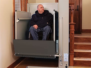 The foldable panel of a wheelchair lift is a safety feature that prevents a wheelchair rider from rolling off