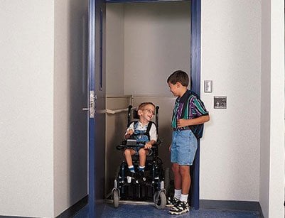 two boys in school vertical platform lift