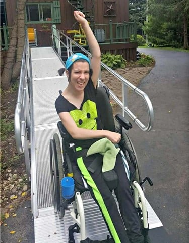 girl excited after first trip down new wheelchair ramp installed by Lifeway Mobility