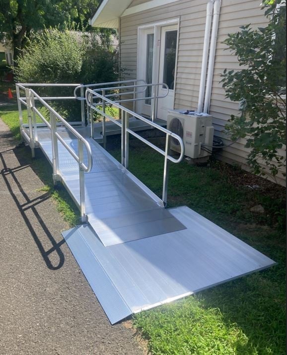 wheelchair ramp with landing pad for safe entry/exit to home