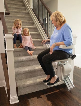 Woman riding Bruno Elan home stair lift