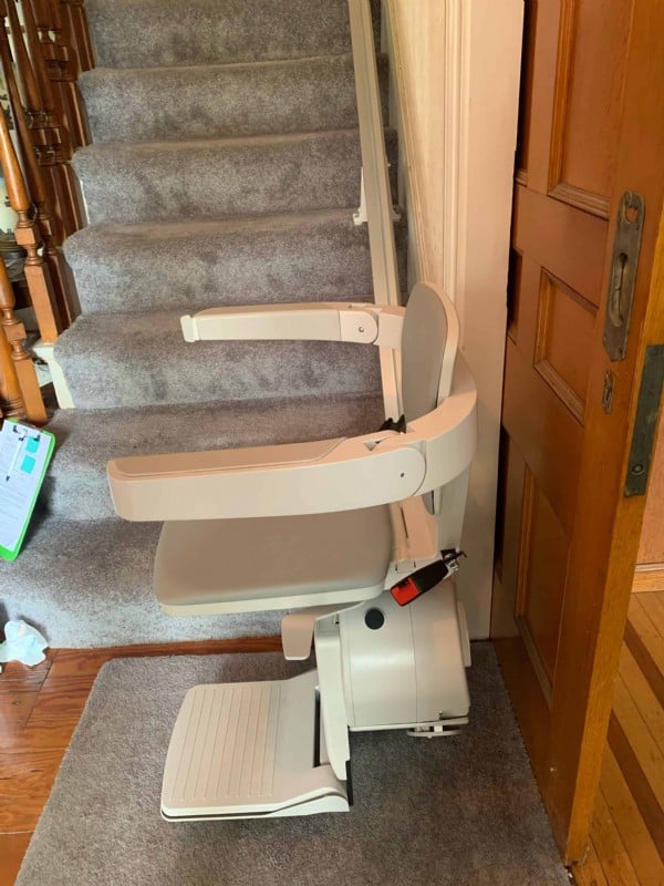 Bruno Elan stairlift at bottom landing of stairs in RI home.jpeg