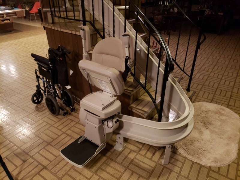 Bruno-Elite-curved-rail-stairlift-folded-at-bottom-of-stairs-in-Wilmette-home.jpg