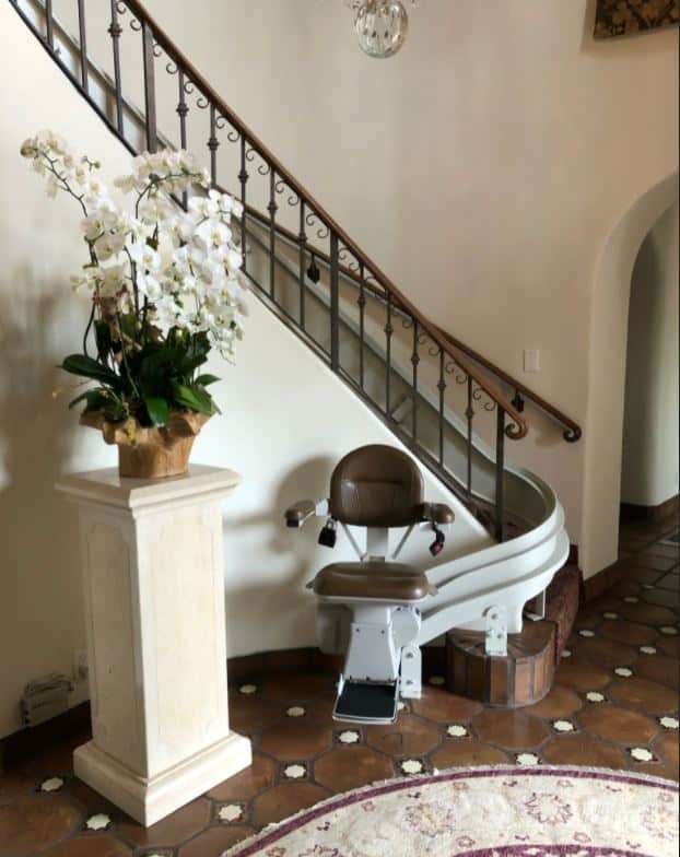 Bruno Elite curved stairlift with brown upholstery installed in home in Los Angeles