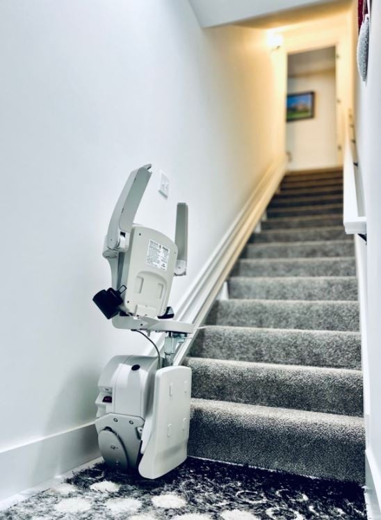 Bruno-stairlift-from-Lifeway-Mobility-with-components-folded-up-at-bottom-landing-of-stairs-in-Columbus-OH-area-home.JPG