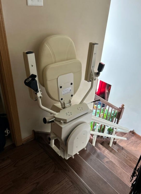 Harmar-Helix-curved-stairlift-at-top-landing-with-components-folded-up-installed-by-Lifeway-Mobility.JPG