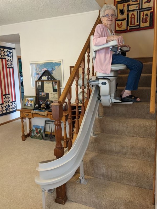 Lifeway-Mobility-customer-riding-new-curved-stairlift-in-home-in-Wichita-KS.jpg