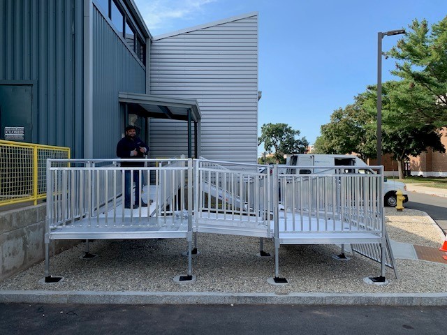 Lifeway-technician-standing-on-wheelchair-ramp-after-install-at-college-in-Connecticut.jpg