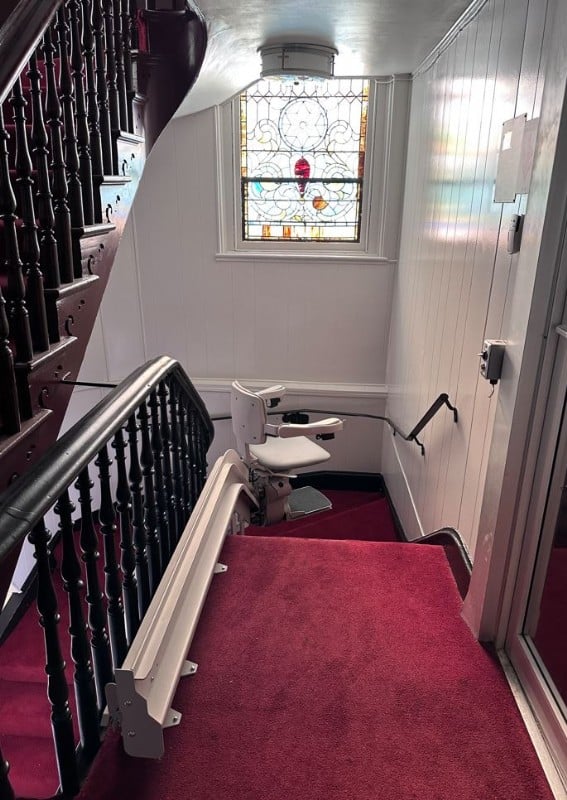 curved-stairlift-in-church-with-rail-overrun-at-to-landing-installed-by-Lifeway-Baltimore.JPG