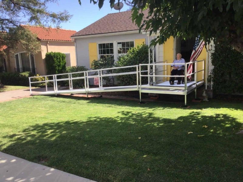 man-in-wheelchair-see-his-new-aluminum-wheelchair-ramp-in-front-of-long-beach-CA-home.JPG