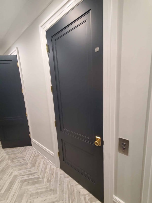 navy-blue-paneled-elvator-swing-door-in-home-on-Chicago-northside.jpg