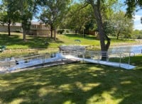 Aluminum wheelchair ramp installed for access to boat in backyard