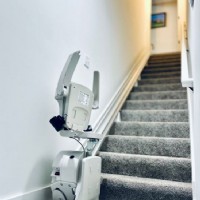 Bruno-stairlift-from-Lifeway-Mobility-with-components-folded-up-at-bottom-landing-of-stairs-in-Columbus-OH-area-home.JPG
