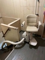 Handicare Freecurve stairlift at top park position in home in Los Angeles