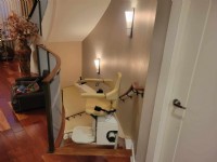 Handicare curved stairlift at top landing of basement stairs in Philadelphia home