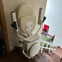 Harmar-Helix-curved-stairlift-at-top-landing-with-components-folded-up-installed-by-Lifeway-Mobility.JPG