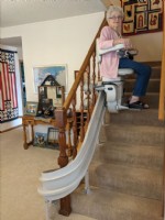 Lifeway-Mobility-customer-riding-new-curved-stairlift-in-home-in-Wichita-KS.jpg